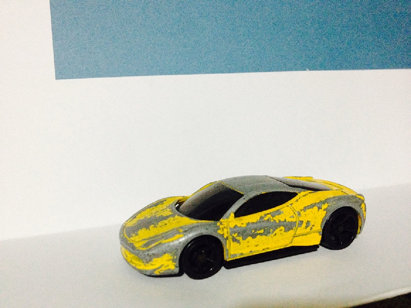 Illustration for article titled Presenting: the most beat-up (but still butt-kicking) 1:64 Ferrari 458 ever